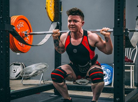 Athlete squatting with a barbell during training
